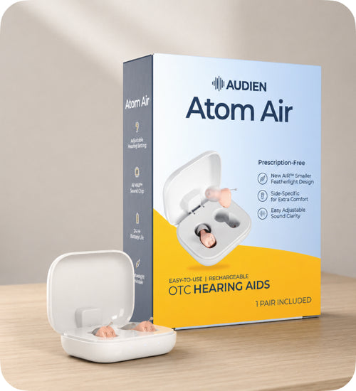 Audien Atom Air hearing aids packaging on a wooden surface with a neutral background