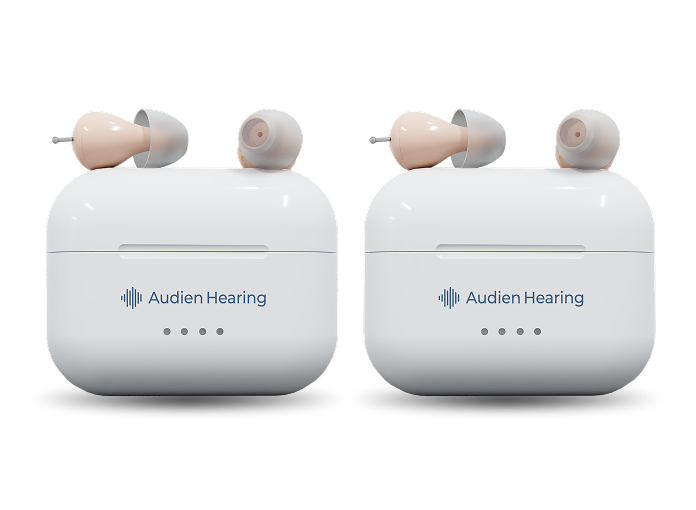 Two white hearing aid cases with ear-shaped covers on a white background, featuring the Audien Hearing logo.