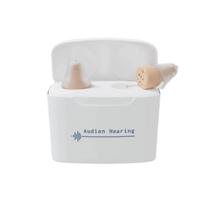 Audien Hearing Atom Pro hearing aids in charging case with logo on front