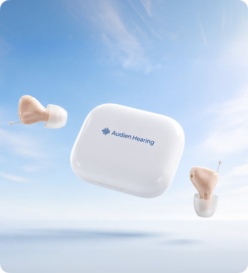 Hearing aid device with Audien Hearing logo on a blue sky background